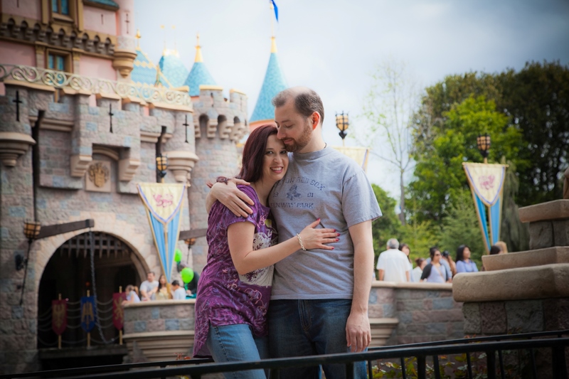 Couple posing in front of Sleeping Beauty Castle