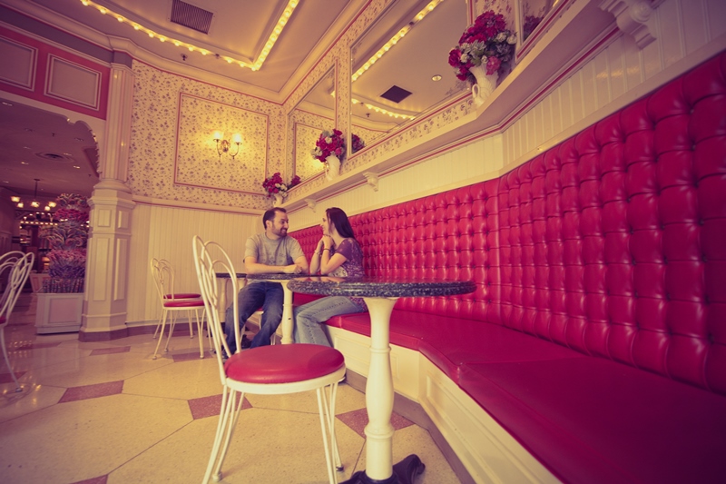 Couple posing at table inside Coke Corner