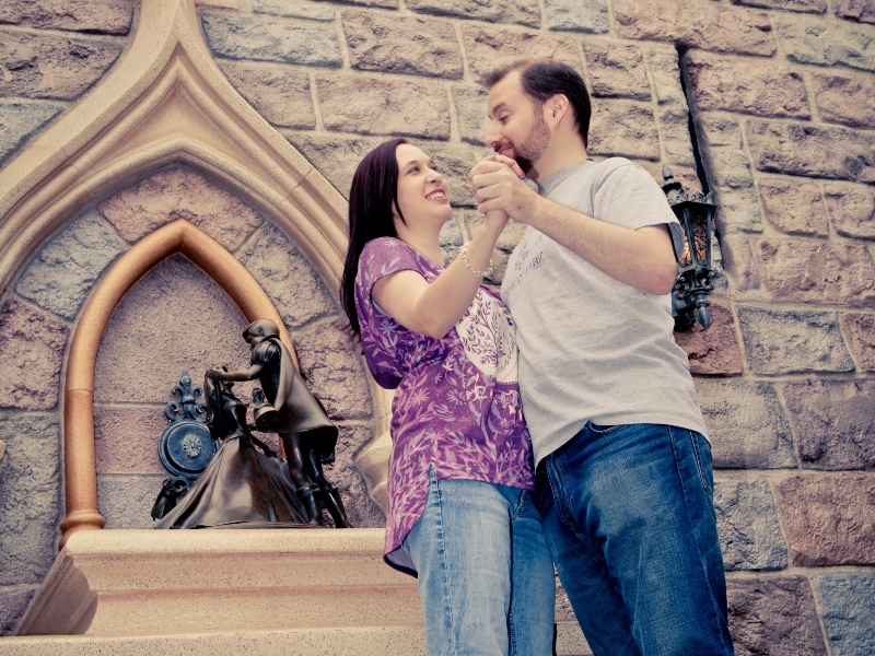 Couple posing at Sleeping Beauty statue