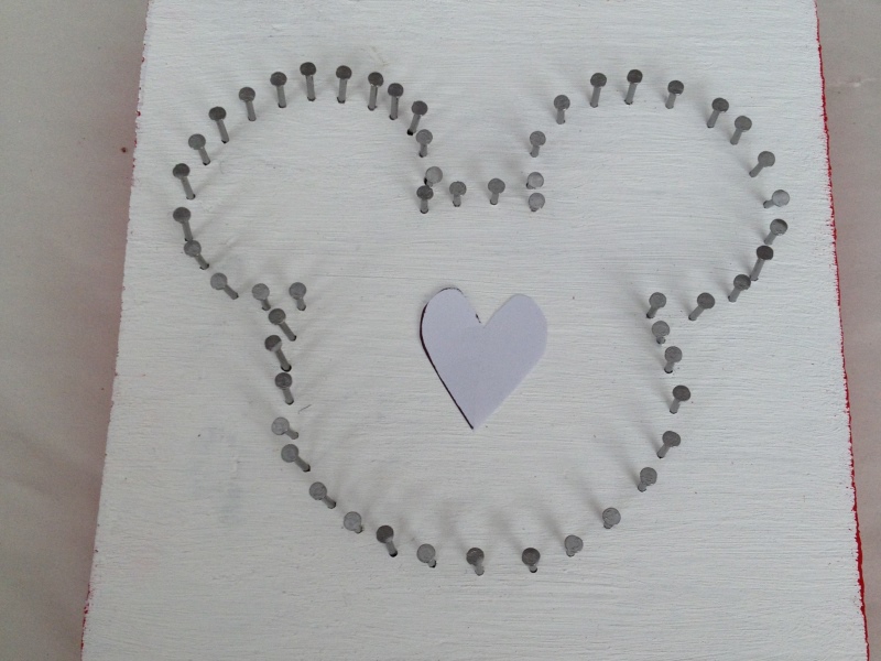 Mickey shape outlined with nails and heart in the center