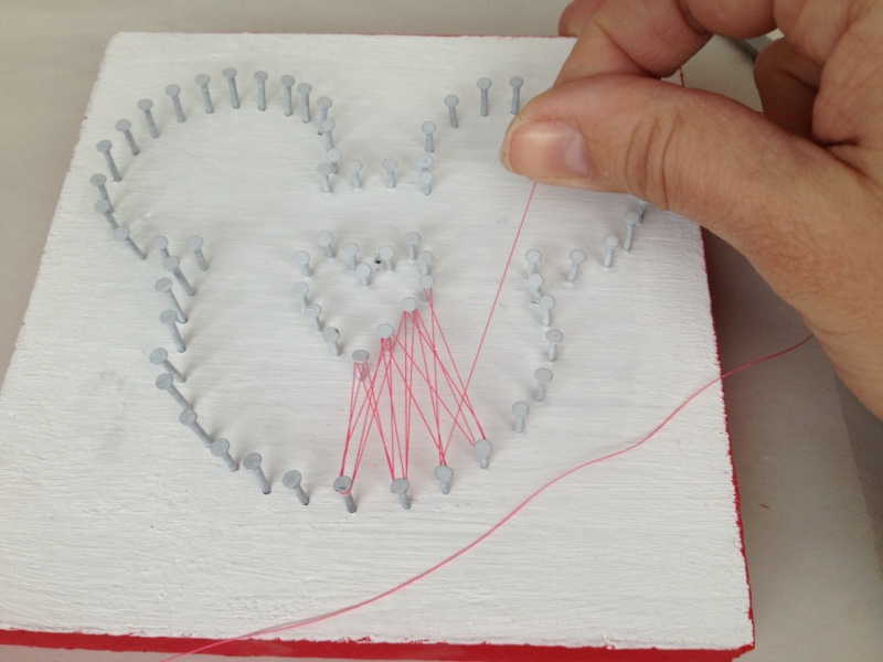 Mickey shape with nails and string criss crossing through the nails