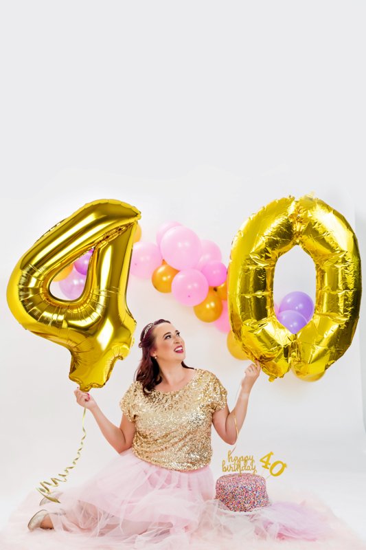 Young Woman Posing with Gray Inflatable Balloons · Free Stock Photo