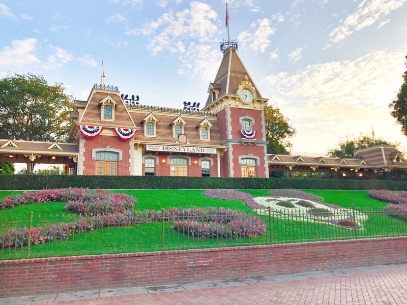 Disneyland train station sitting behind Mickey floral mural