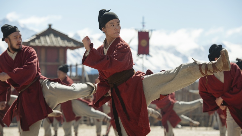 Mulan in warrior training, kicking her leg in a fighting pose