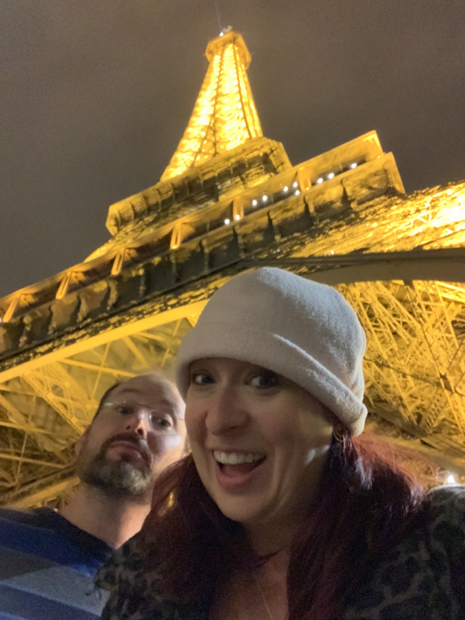 Selfie in front of Eiffel Tower at night