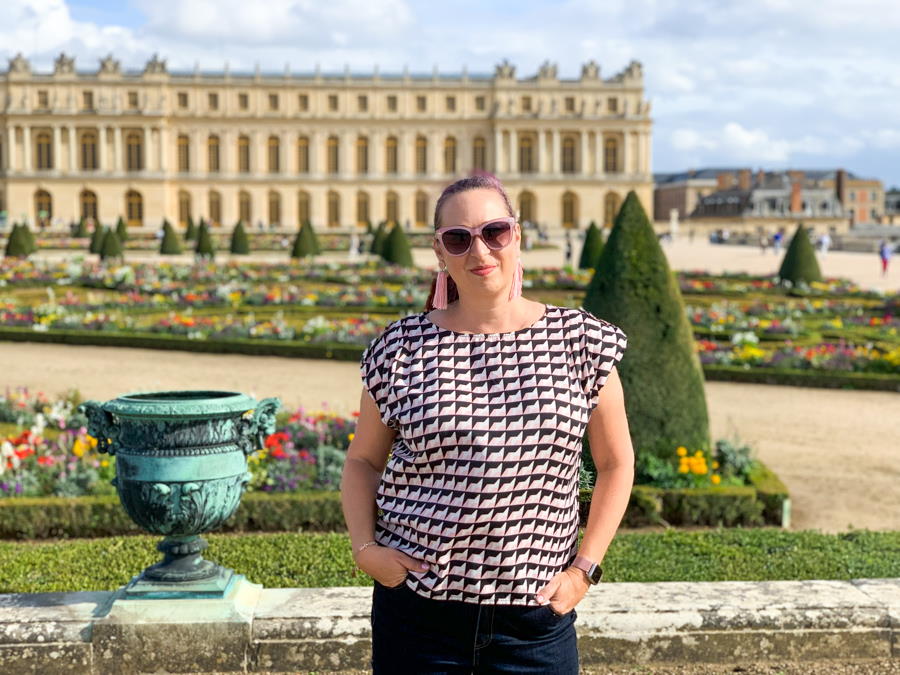 Woman standing in front of Versailles palace in France