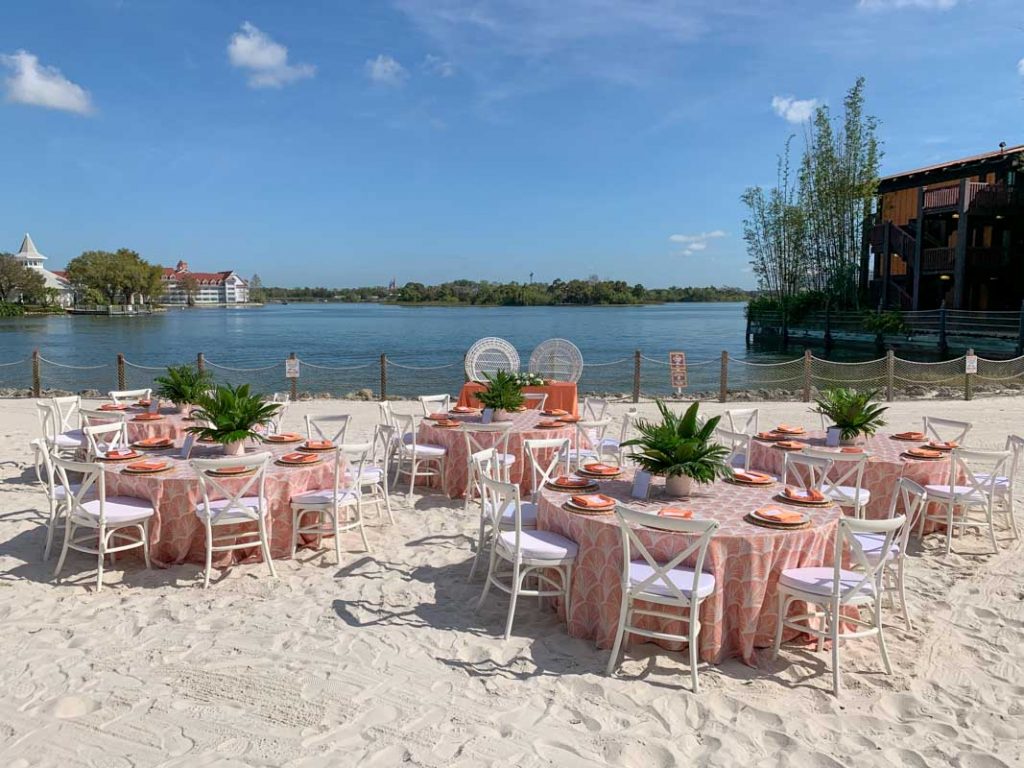 Wide shot of wedding reception tables at luau beach