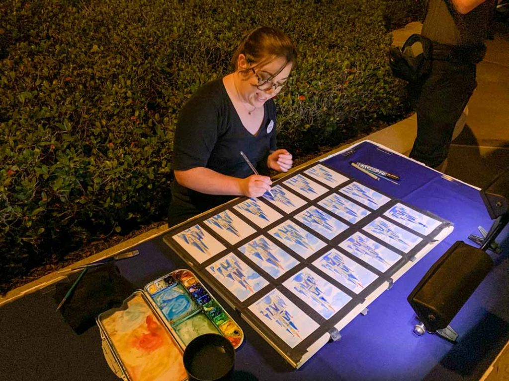 Woman painting pictures of Cinderella Castle