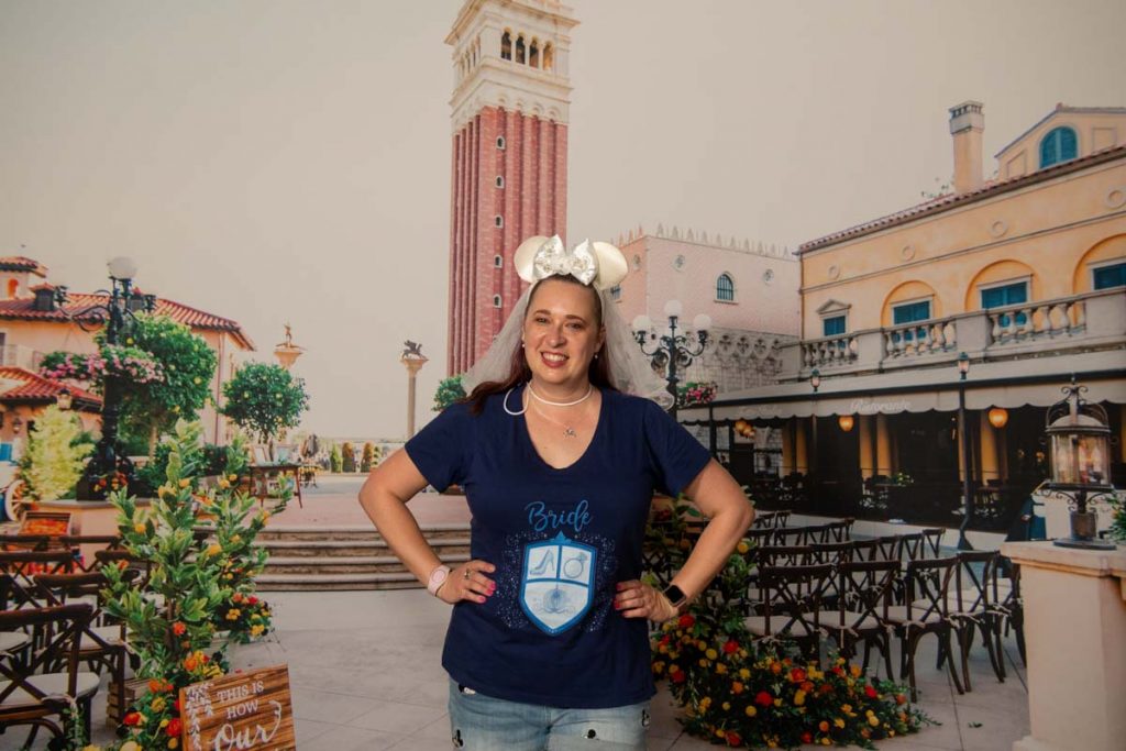 Woman in front of backdrop of Italy World Showcase at EPCOT