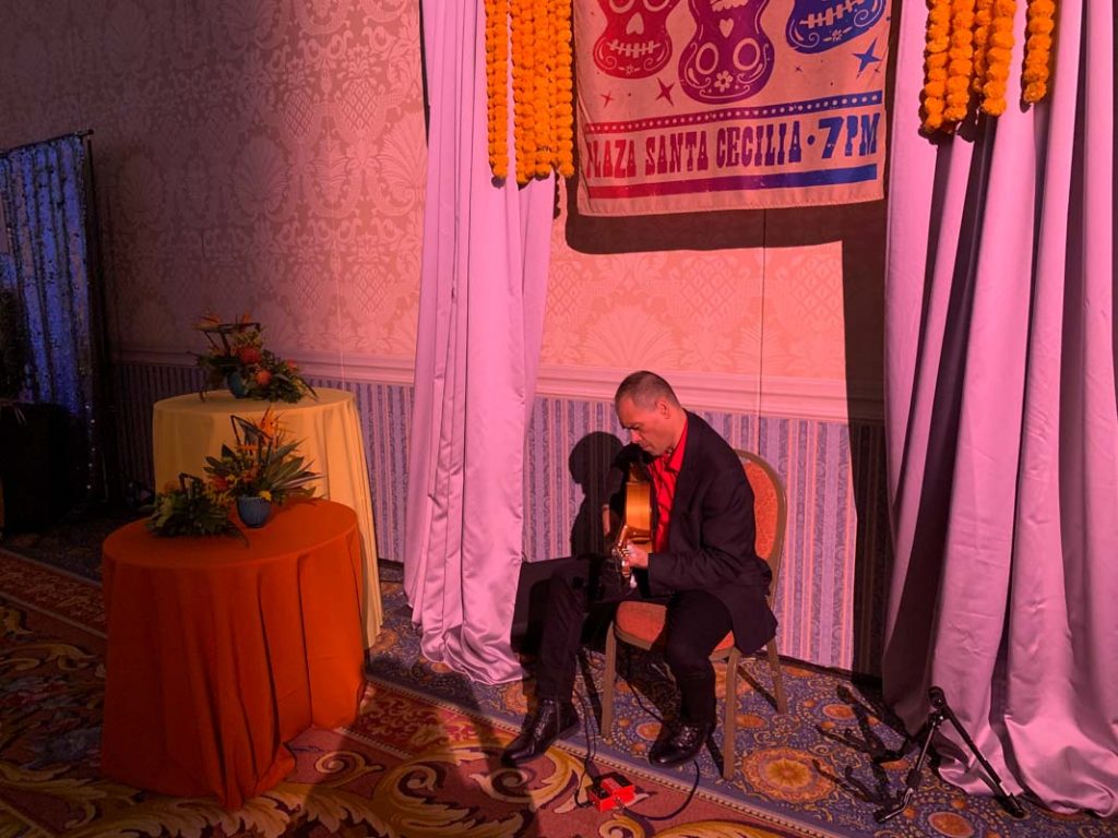 Man playing guitar at wedding reception