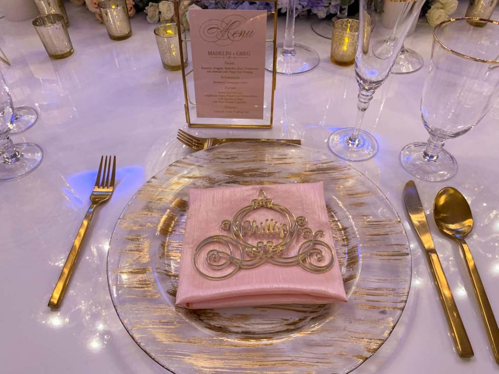 Close up of reception table setting with carriage shaped place card