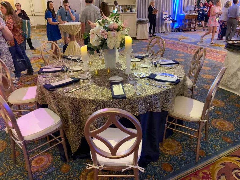 Table with gold tablecloth and 8 chairs