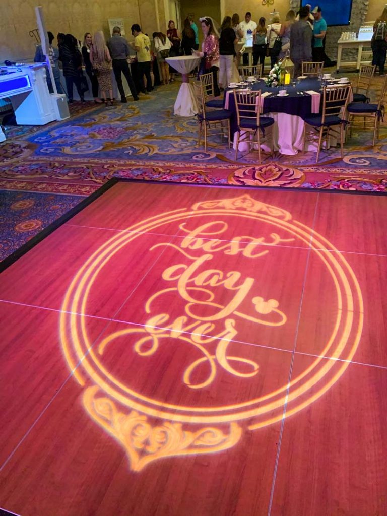 Dance floor with gobo light that reads "best day ever"