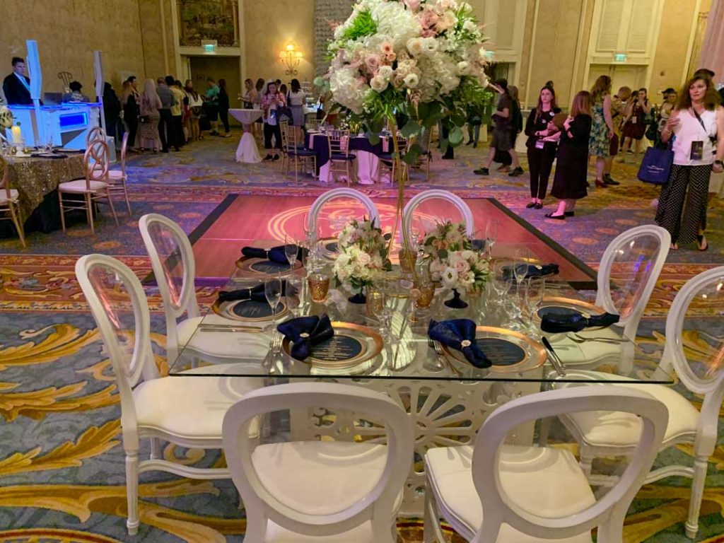 Wide shot of wedding reception room showing reception table and dance floor