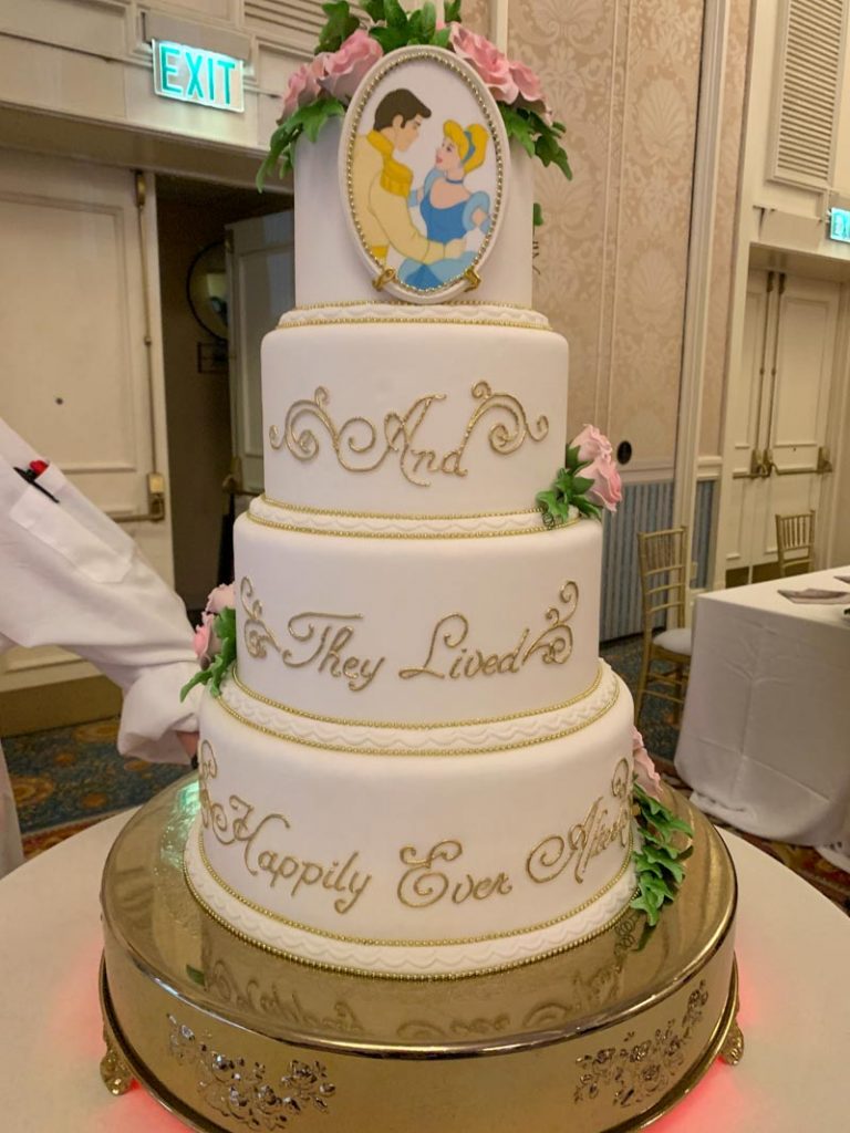 white wedding cake that reads "and they lived happily ever after"