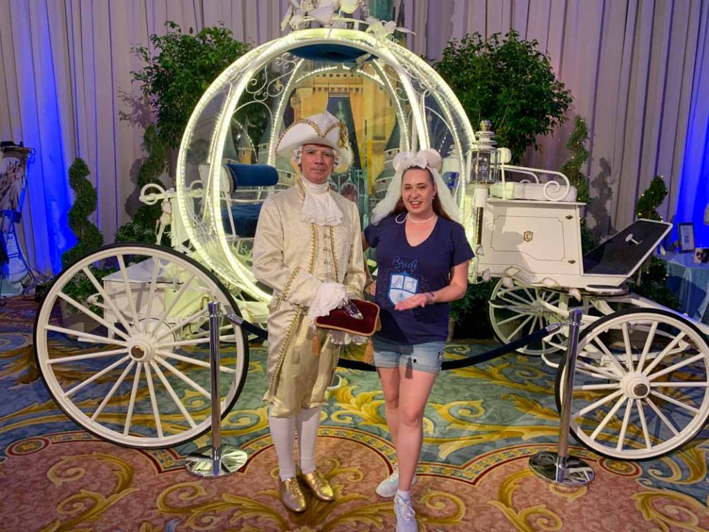 Woman standing in front of royal carriage