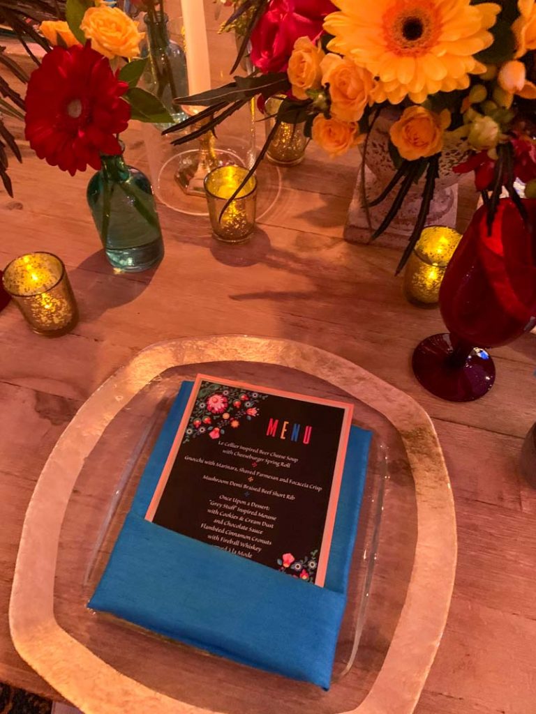 Close up of colorful wedding reception menu and blue folded napkin