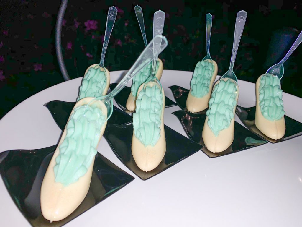 dessert of white chocolate in the shape of glass slipper with blue cream