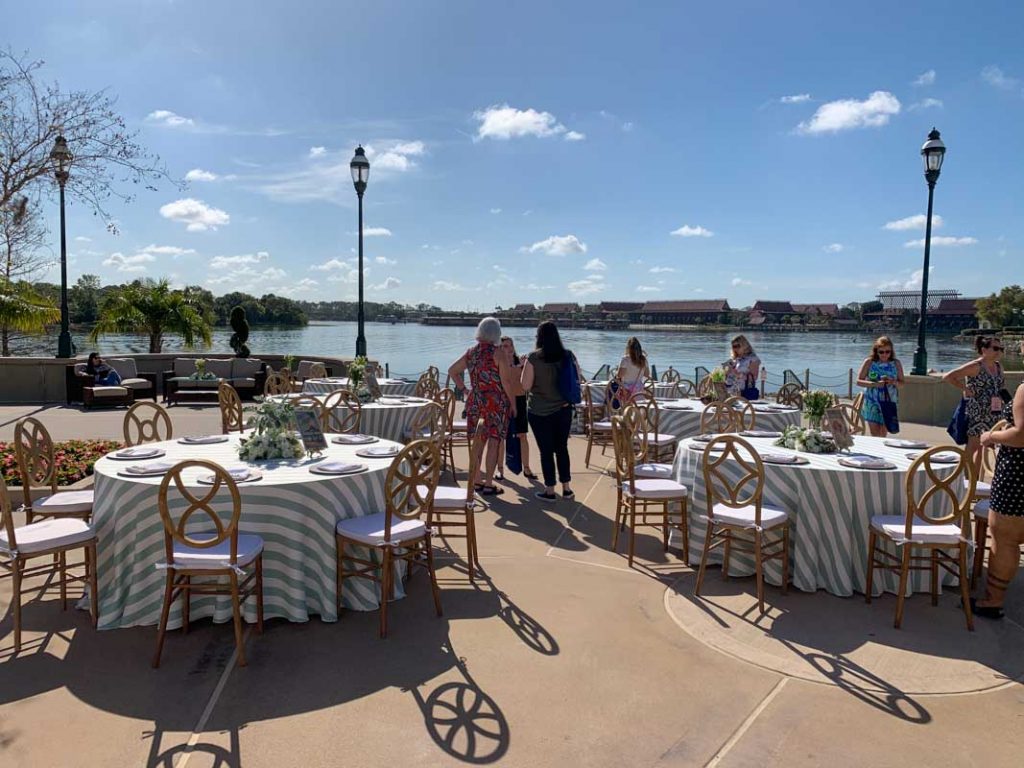 Wide shot of wedding reception tables at summerhouse patio