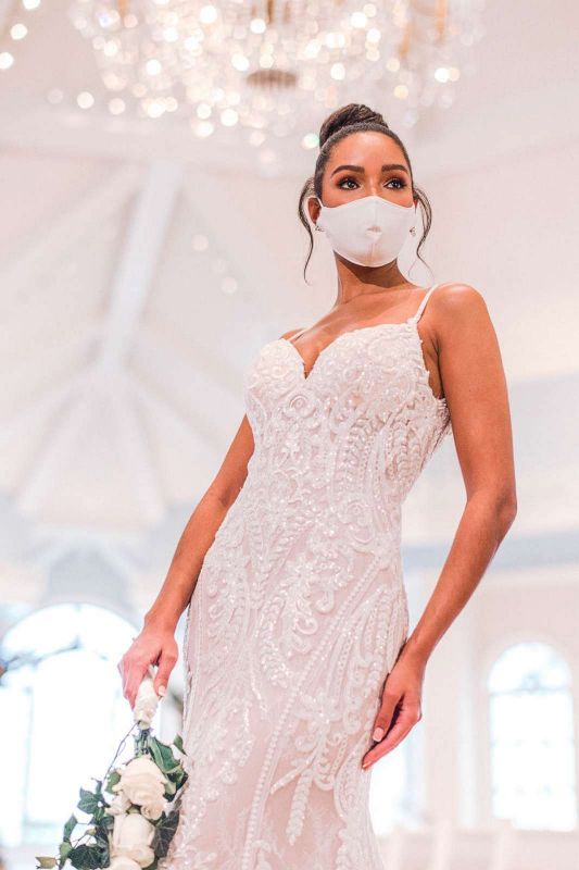 Woman wearing wedding gown and white face mask