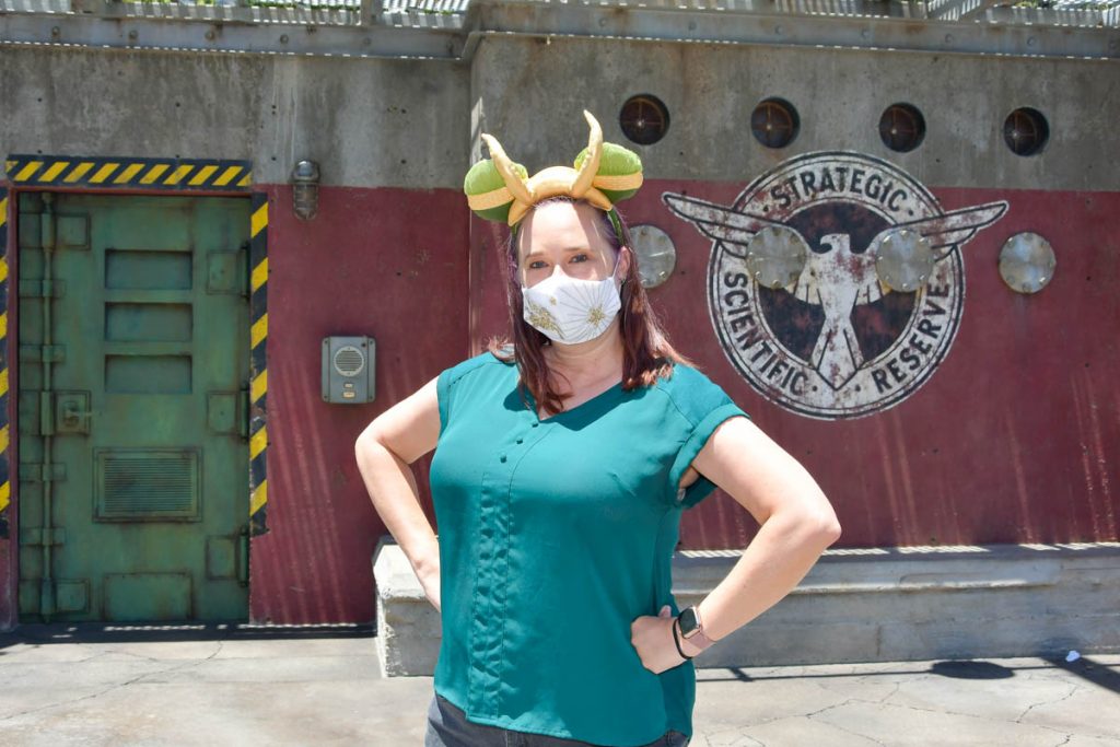 Woman posing in front of mural at Avengers Campus