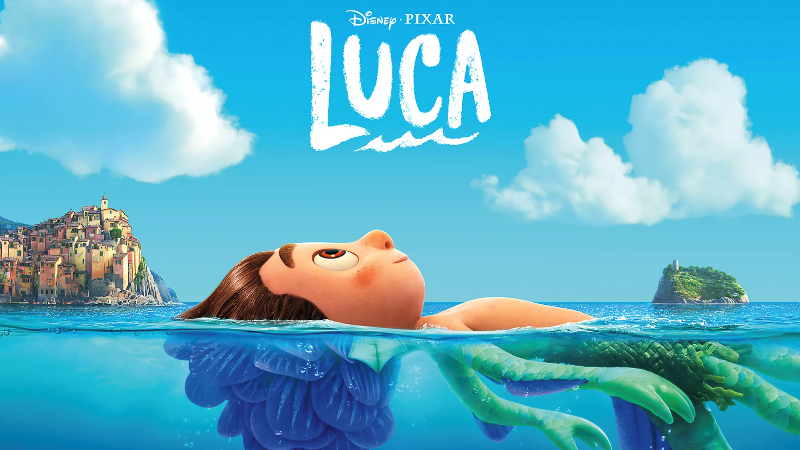 Luca laying in water. Above the water he is human form. Below the water's surface he is a sea monster.