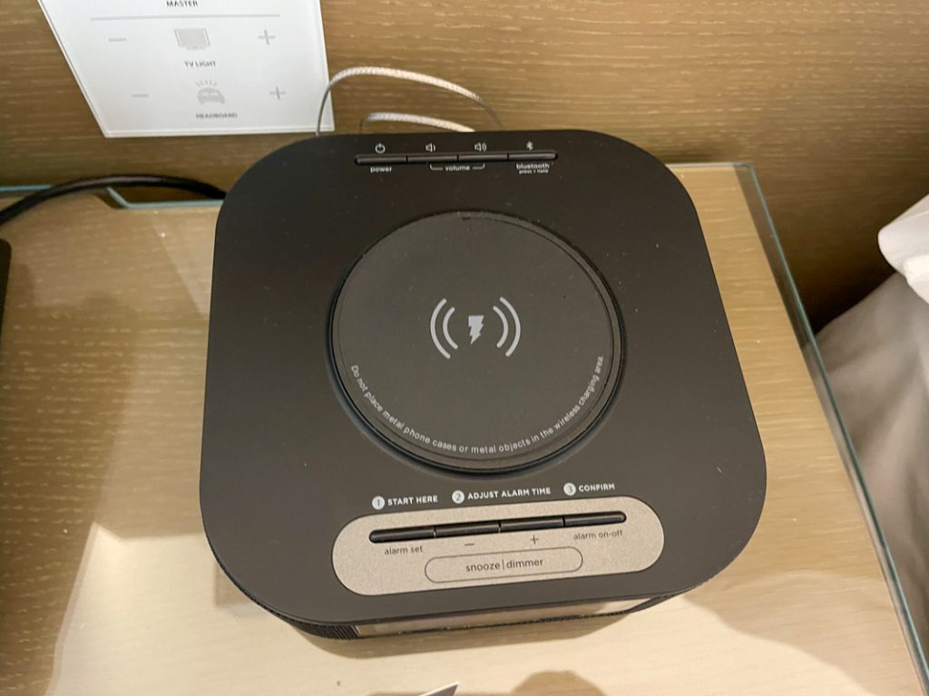 Interior of Westin Anaheim hotel room showing wireless phone charger on top of alarm clock