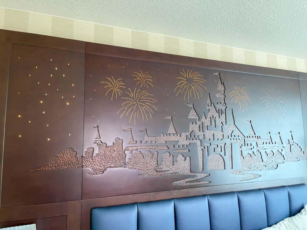 Close up of brown headboard with fiber optic lights shaped like fireworks at Disneyland Hotel room