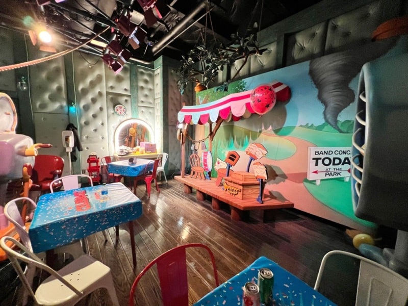 Band Concert Room inside Mickey Mouse's House at Disneyland, with three colorful tables and 10 chairs