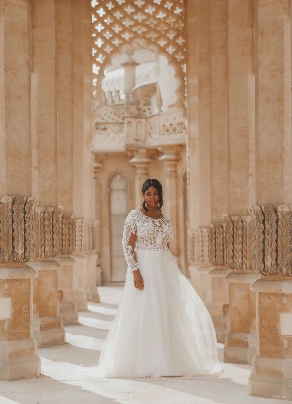 Woman wearing wedding dress surrounded by marble columns