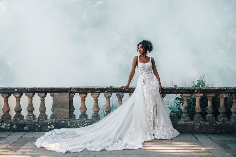 Woman wears wedding dress with long train inspired by Disney princess Tiana