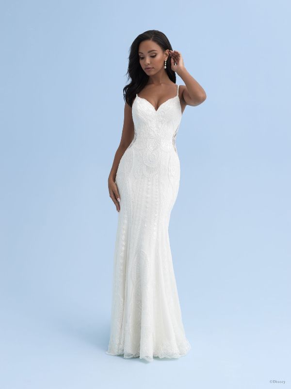 African American model wears form fitting wedding dress against blue backdrop