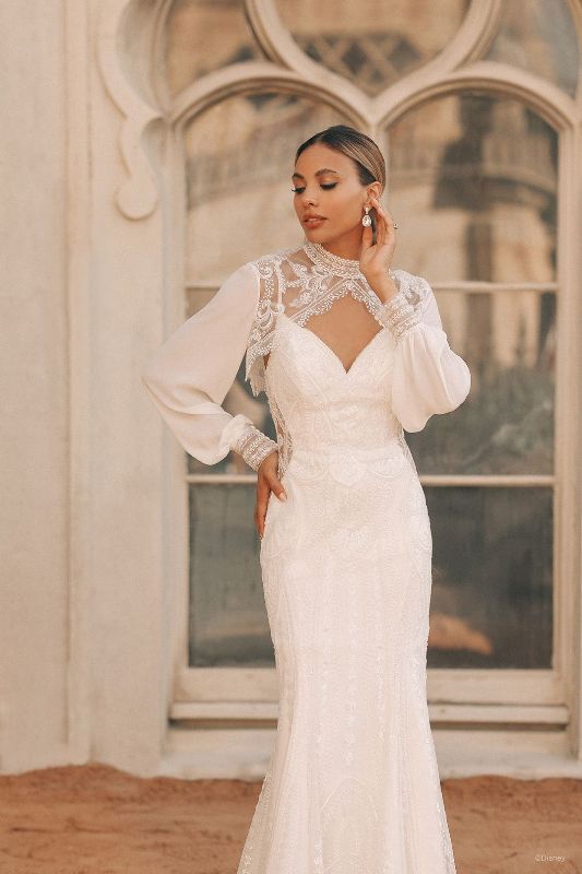 Woman wears form fitting wedding gown with long sleeves