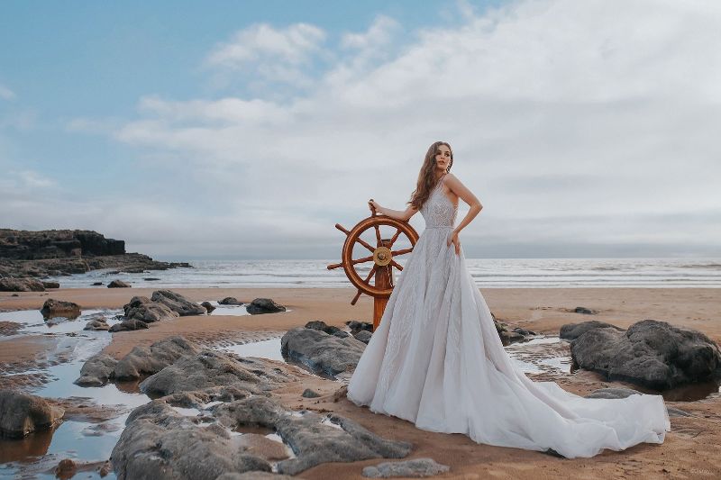 Bride wearing wedding dress on the beach