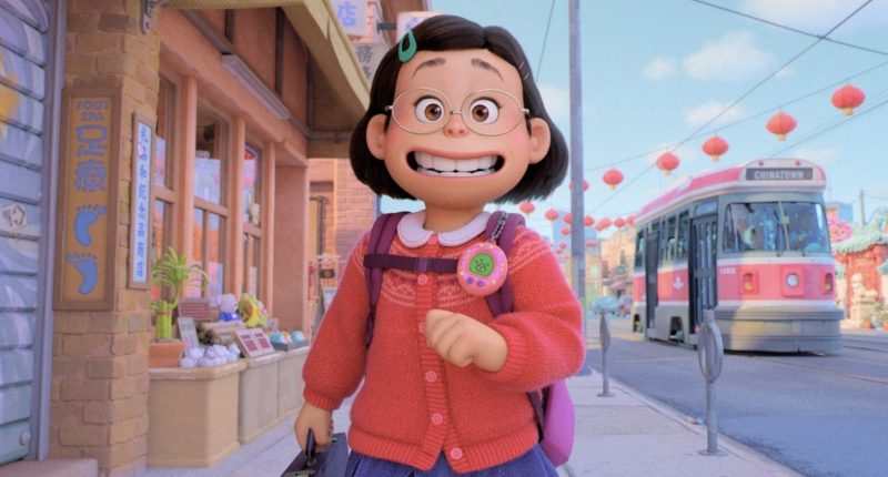 Still from the movie Turning Red, with Mei walking down the street, happily smiling