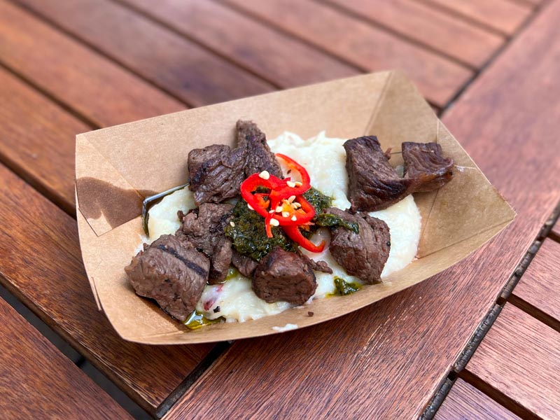 Beef tenderloin and chimichurri sauce over mashed potatoes