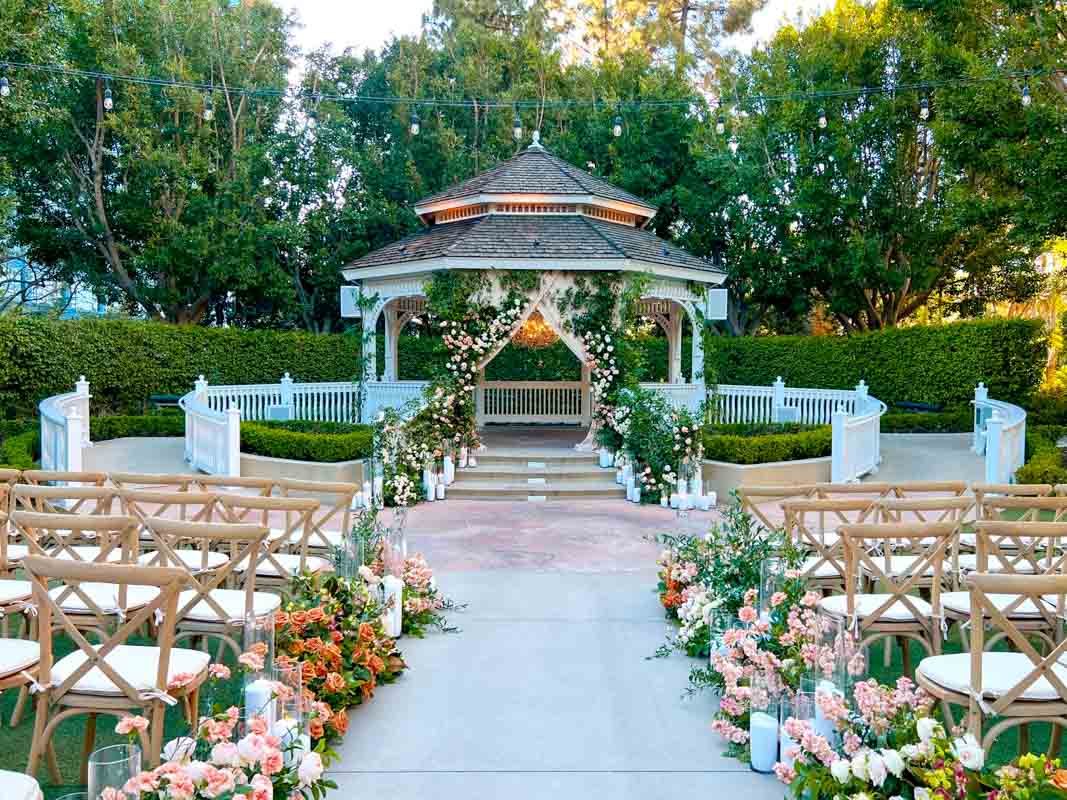 Rose Court Garden at Disneyland Hotel decorated with greenery, white, and peach roses, and chandelier