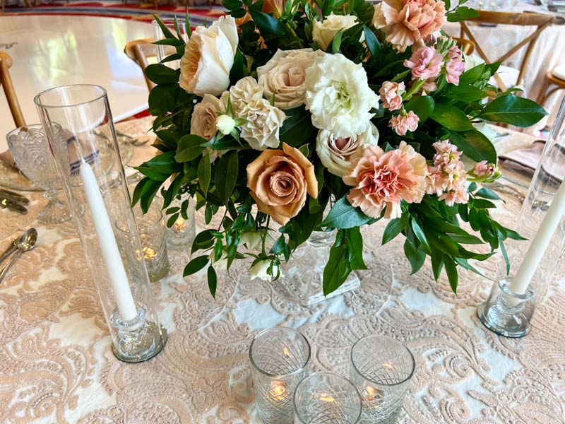 Close up of small wedding centerpiece of white and pink flowers in a crystal vase