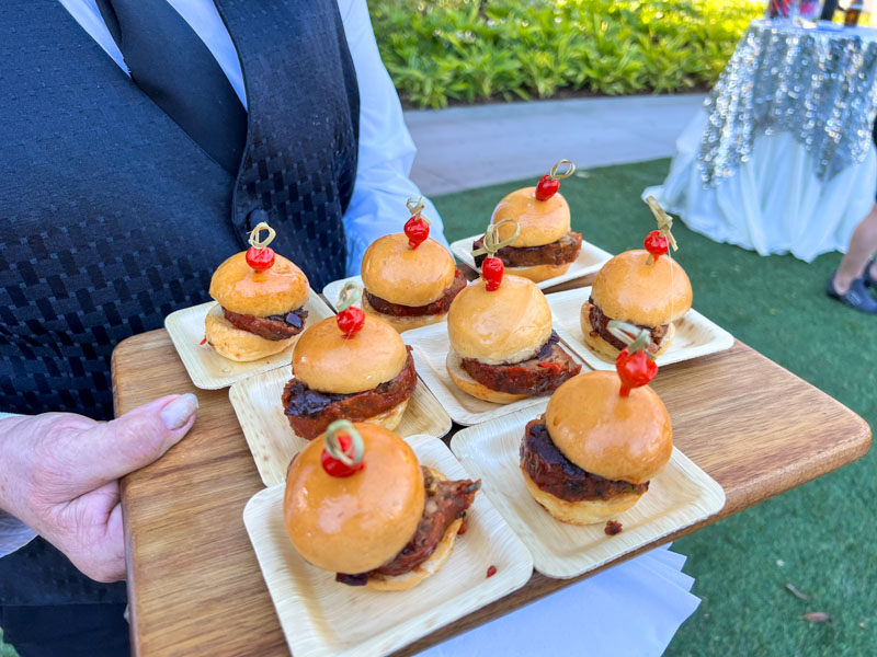 Tray of small sliders with decorated toothpicks