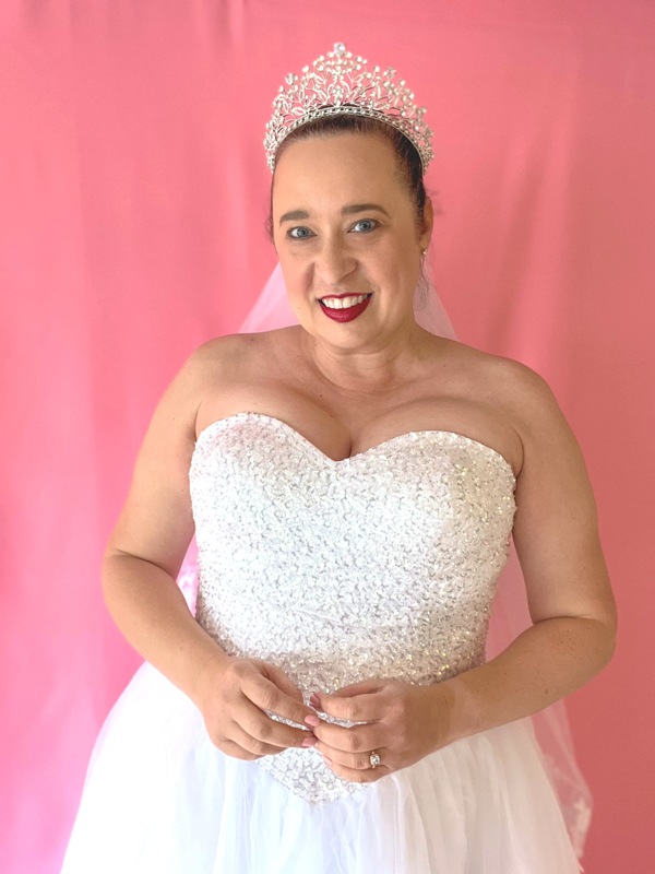 Bride wears white ballgown with sweatheart neckline and silver tiara