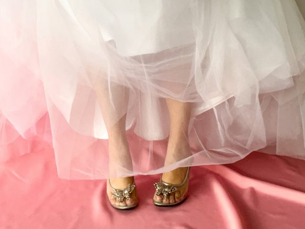 Close up of clear plastic bridal shoes with butterfly clips