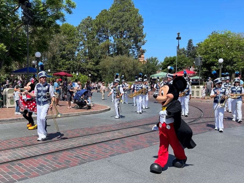 Mickey and Minnie lead the Disneyland Band down Main Street USA