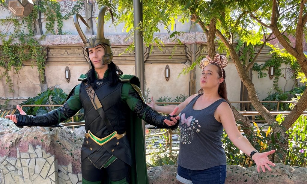 Costumed character Loki poses with a Guest at Disneyland Resort