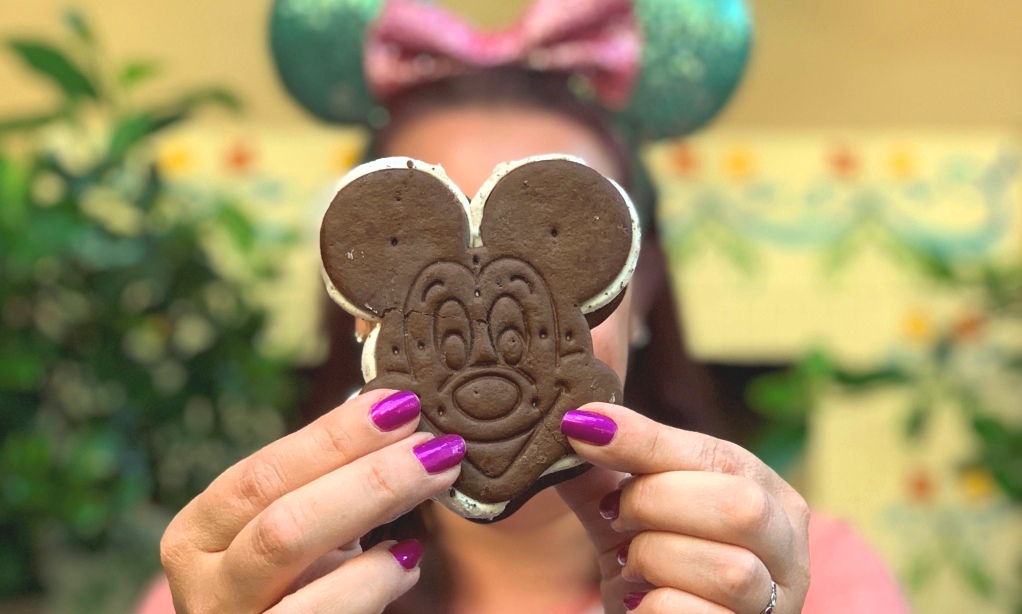 Woman holding Mickey Ice Cream Sandwich up in front of her face