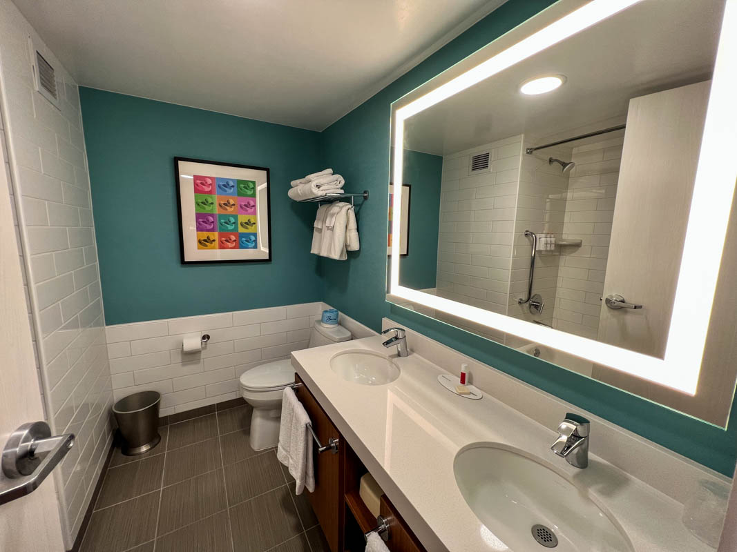 Interior bathroom of guest hotel room at Howard Johnson near Disneyland showing double sinks and toilet
