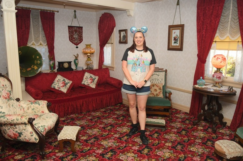 Woman poses inside Walt's apartment at Disneyland