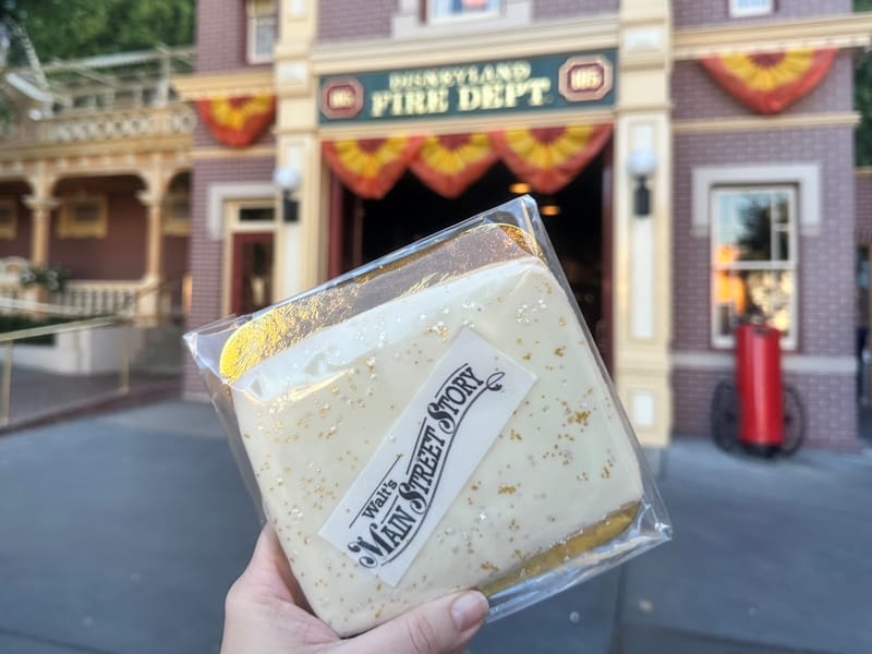 Walt's Main Street Story tour cookie held up in front of the Main Street Fire Station