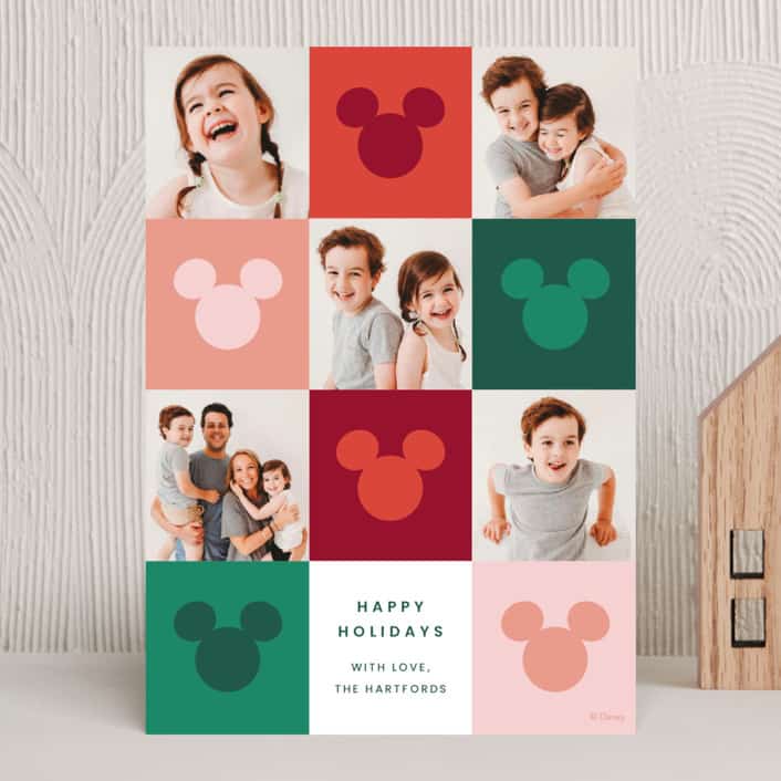 Holiday card with red, green, and white grid alternating with Mickey head shapes and family photos