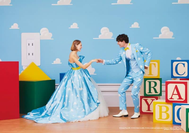 Woman and man wears ballgown and suit inspired by wallpaper in Andy's Room from Toy Story