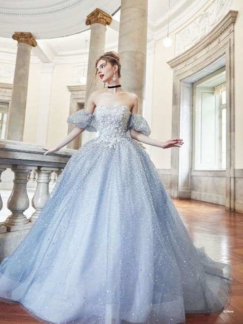 Woman wearing light blue ballgown inspired by Cinderella